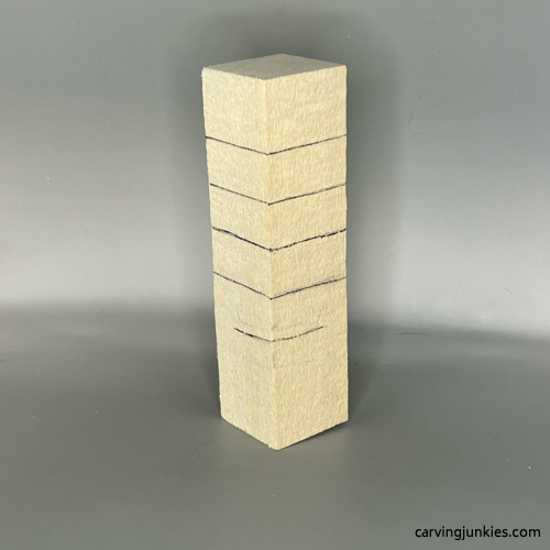 Guidelines are sketched on wood carved Christmas tree gnome