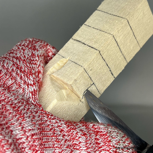 Carving side of the nose on wood carved Christmas tree gnome