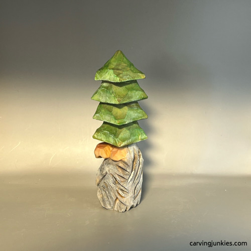 Painted left view of wood carved Christmas tree gnome