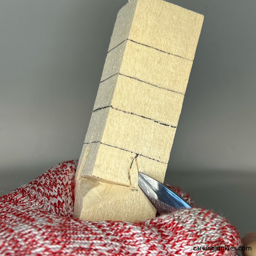 Making pyramid cut on side of the nose on wood carved Christmas tree