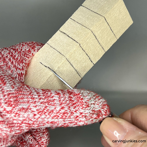 Making a stop cut on wood carved Christmas tree gnome