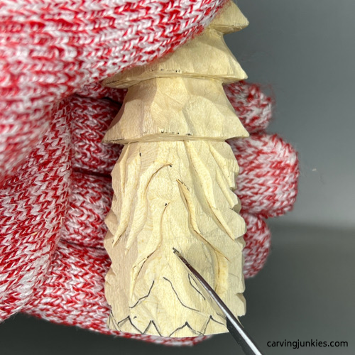 Carving back of beard on wood carved Christmas tree gnome