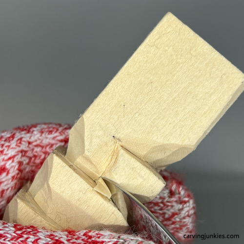 Carving top of nose on wood carved Christmas tree