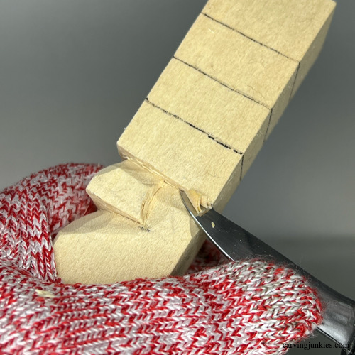 Carving top side of nose on wood carved Christmas tree