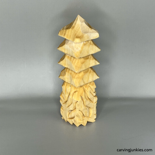 Back view of unpainted wood carved Christmas tree gnome