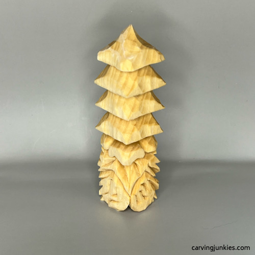 Front view of unpainted wood carved Christmas gnome