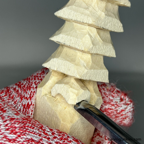 Using U-gouge to carve nostrils on wood carved Christmas tree gnome