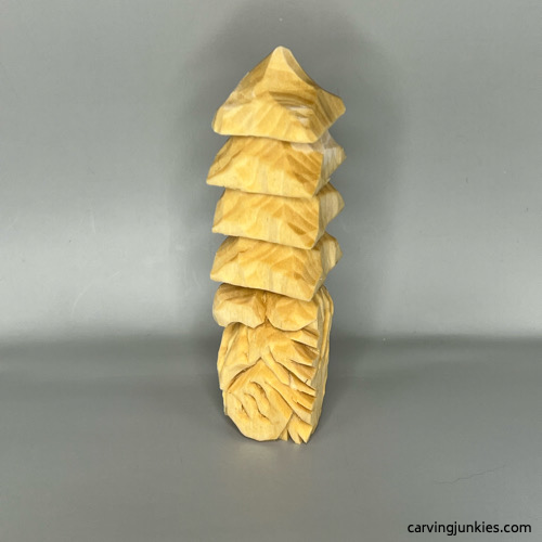 Left view of unpainted wood carved Christmas tree gnome