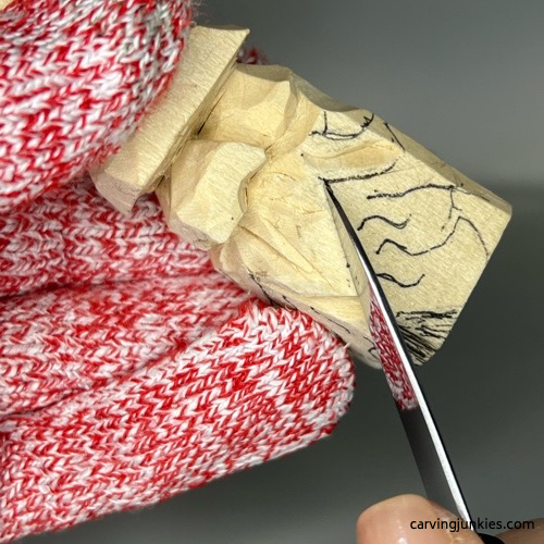 Carving beard on front of wood carved Christmas gnome