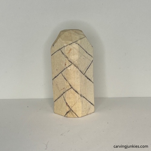 Back details are added to wood carved Christmas tree ornament Cross hatch design is drawn on back of wood carved Christmas tree ornament