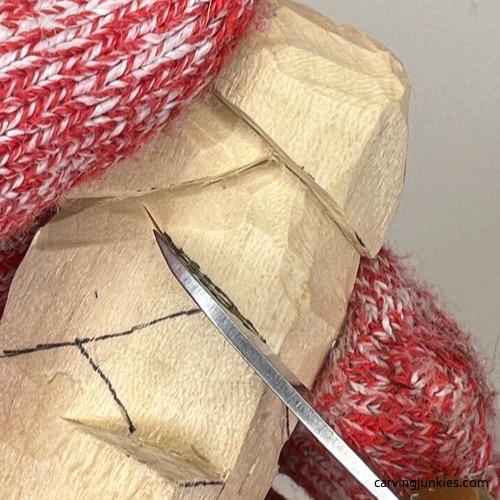 Separating branches on wood carved Christmas tree ornament Separating the cross hatch lines on wood carved Christmas tree ornament