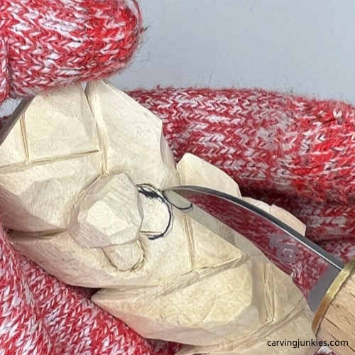 Separating eyes on wood carved Christmas tree ornament Carving eyes on wood carved Christmas tree ornament