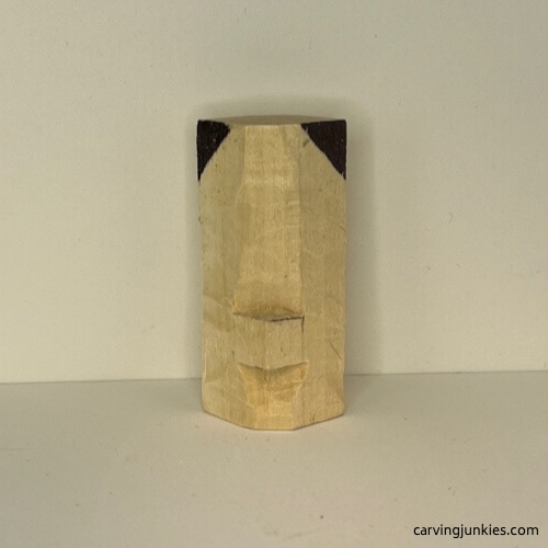 Marked wood on top of wood carved Christmas tree ornament Wood marked for removal on top of wood carved Christmas tree ornament