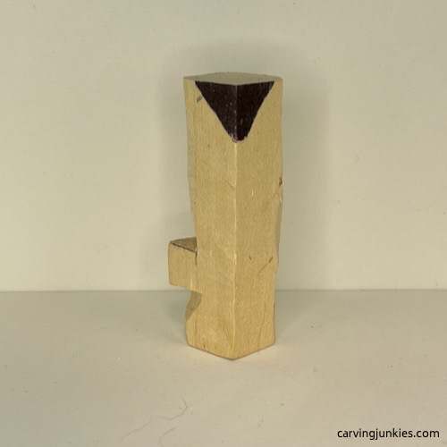 Left side of wood marked on wood carved Christmas tree ornament Left view of wood marked for removal on wood carved Christmas tree ornament