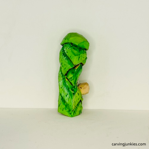 Right side of wood carved Christmas tree ornament after painting Right side of painted wood carved Christmas tree ornament