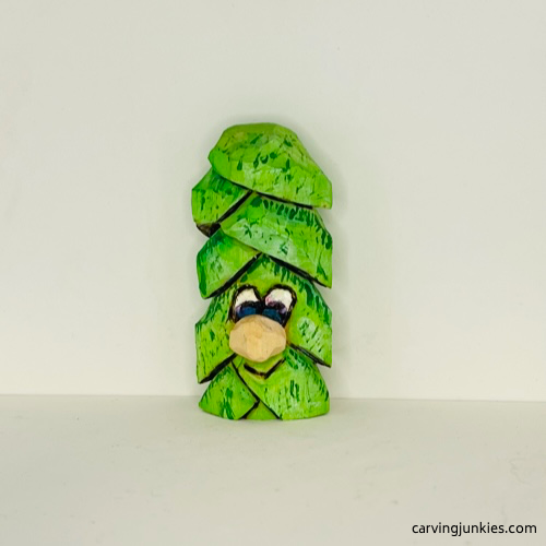 Painted wood carved Christmas tree ornament from the front Front of painted wood carved Christmas tree ornament