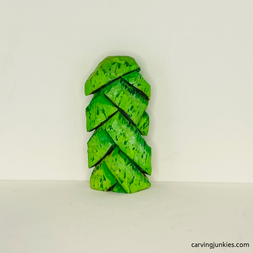 Back of wood carved Christmas tree ornament after painting Back view of painted wood carved Christmas tree ornament