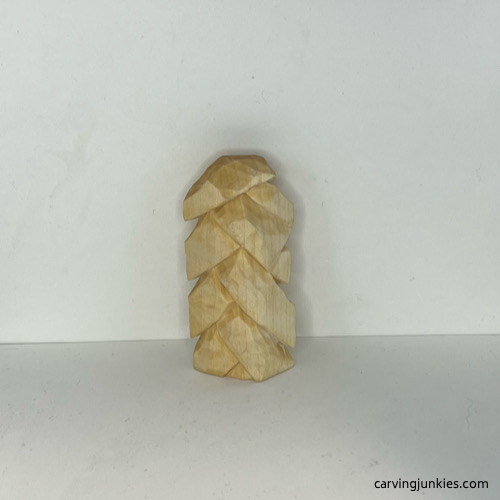 Back of wood carved Christmas tree ornament before painting Back view of unpainted wood carved Christmas tree ornament