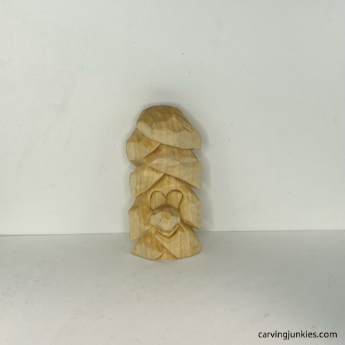 Front of wood carved Christmas tree ornament before painting Front view of unpainted wood carved Christmas tree ornament