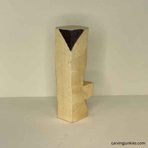 Left side of marked wood for removal on wood carved Christmas tree ornament Wood marked for removal on right side of wood carved Christmas tree ornament