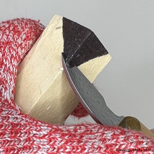 Removing wood from top of wood carved Christmas tree ornament Slicing wood off wood carved Christmas tree ornament