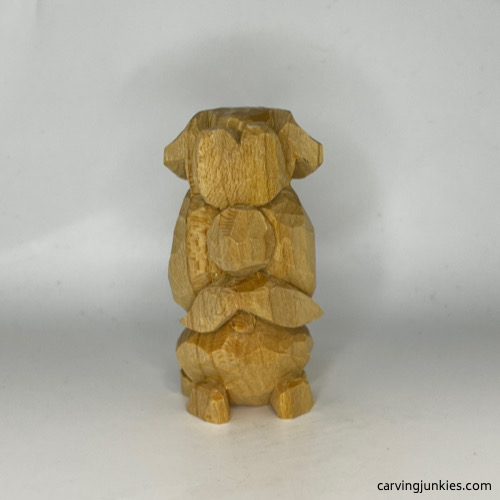 Ears are cut on wooden dog carving