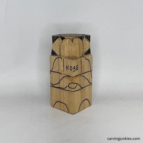 Wood marked for removal on carved wooden dog