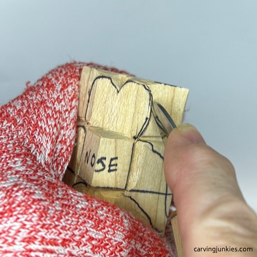 Making pencil cut on wooden carved dog