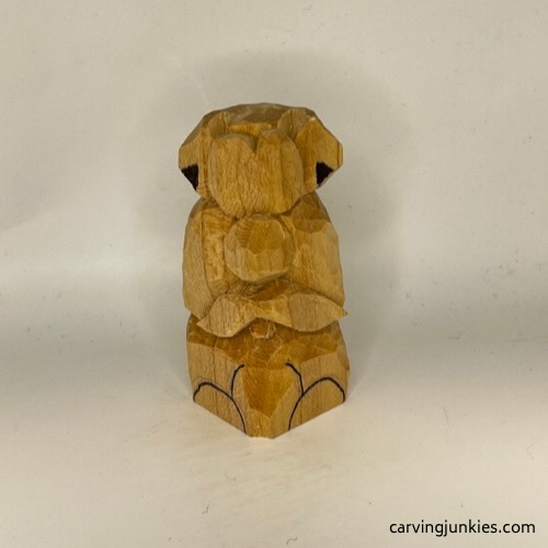 Front legs on wooden dog carving marked for removal