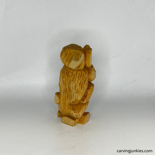 Right view of unpainted carved wooden dog