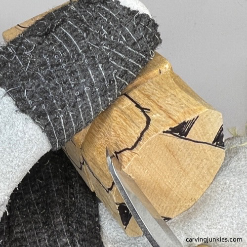 V cut on wooden carved dog