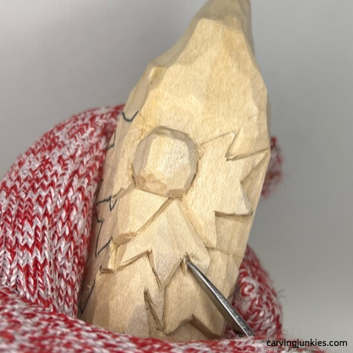 Separating leaves on wood carved autumn gnome Carving leaves on fall gnome wood carving
