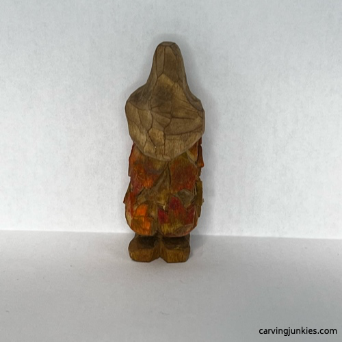 Back of painted wood carved autumn gnome Painted back of fall gnome wood carving