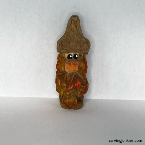Front view of painted wood carved autumn gnome Painted front of fall gnome wood carving