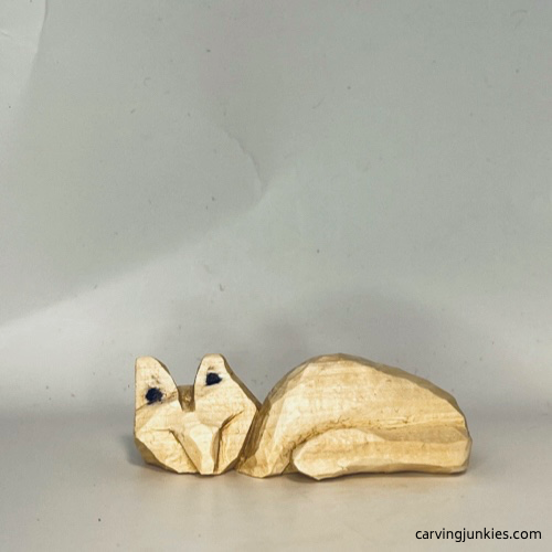 Ears are marked for pyramid cuts on wood carved fox