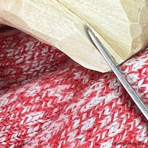 Shaping the tail on a wood carved fox