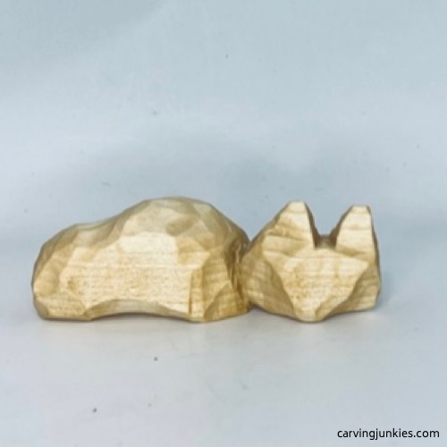 Back view of unpainted wood carved fox