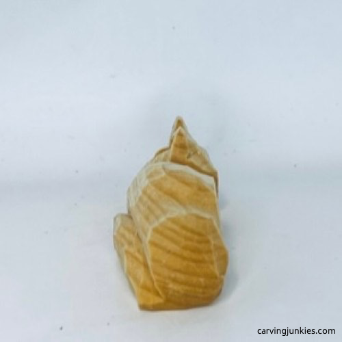 Left view of unpainted wood carved fox