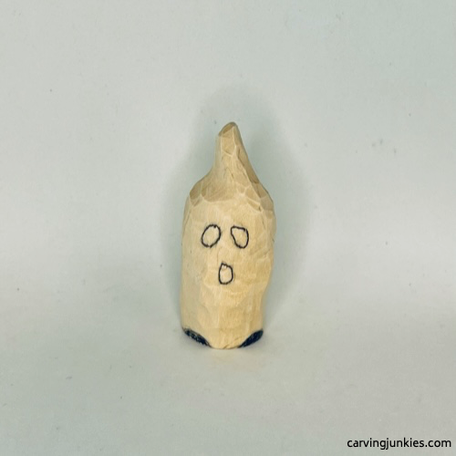 Sketched details on front of wood carved ghost