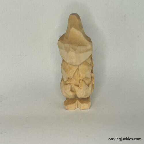 Back of unpainted wood carved autumn gnome Back view of unpainted fall gnome wood carving