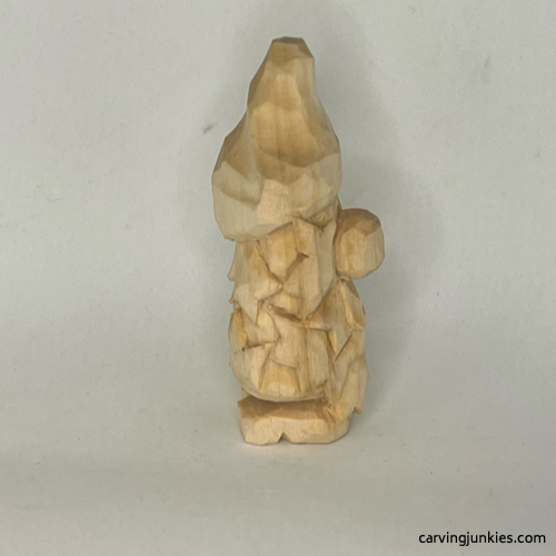 Right side of unpainted wood carved autumn gnome Unpainted left view of fall gnome wood carving