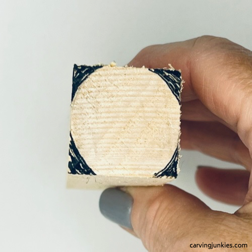 Areas are marked for wood removal on wood carved ice cream cone Guidelines for wood carved ice cream cone