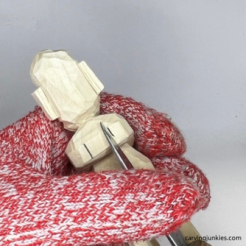 Cutting back shoulders on carved old man