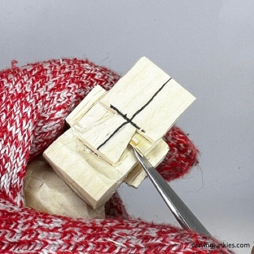 Carving cheeks on carved old man