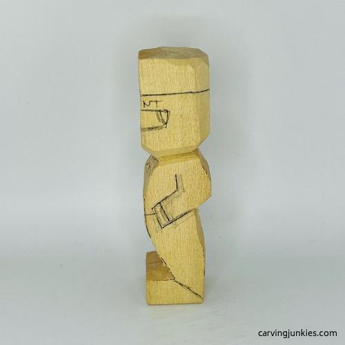 Left view of details drawn on little man caricature carving