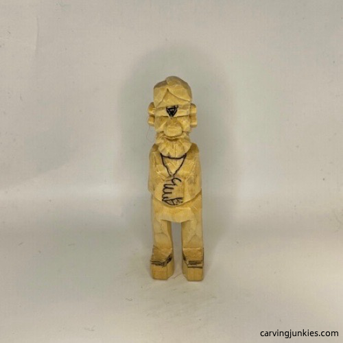 Front of carved old man is marked