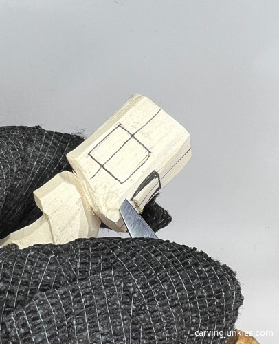 Removing wood on face of carved old man