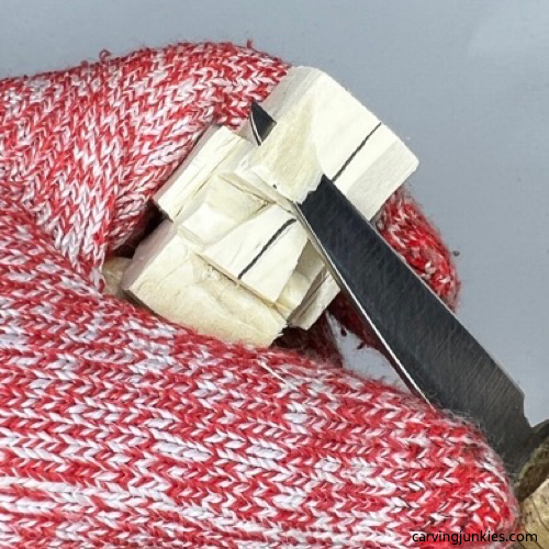 Cutting back forehead on carved old man