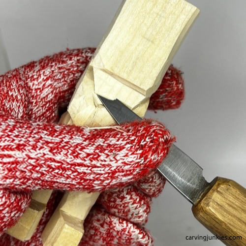 Cutting back neck on carved old man