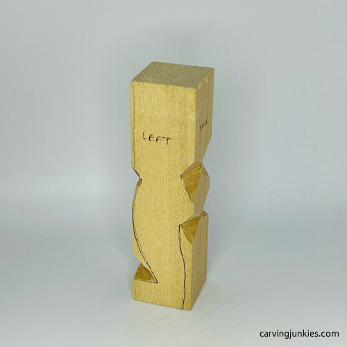 Notches cut on little man caricature carving